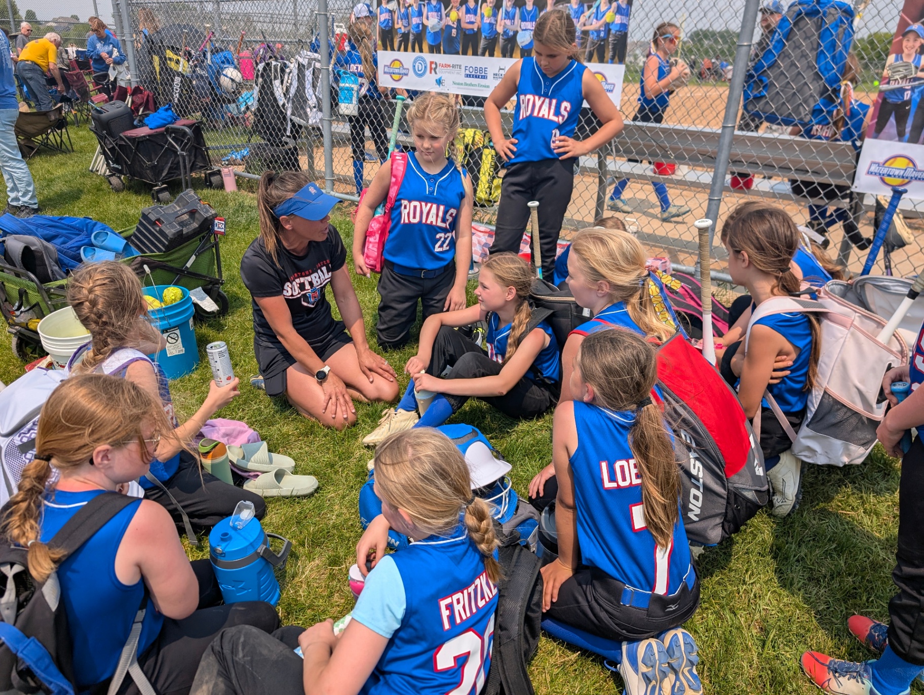 Bethany Loether talking with her softball team between games