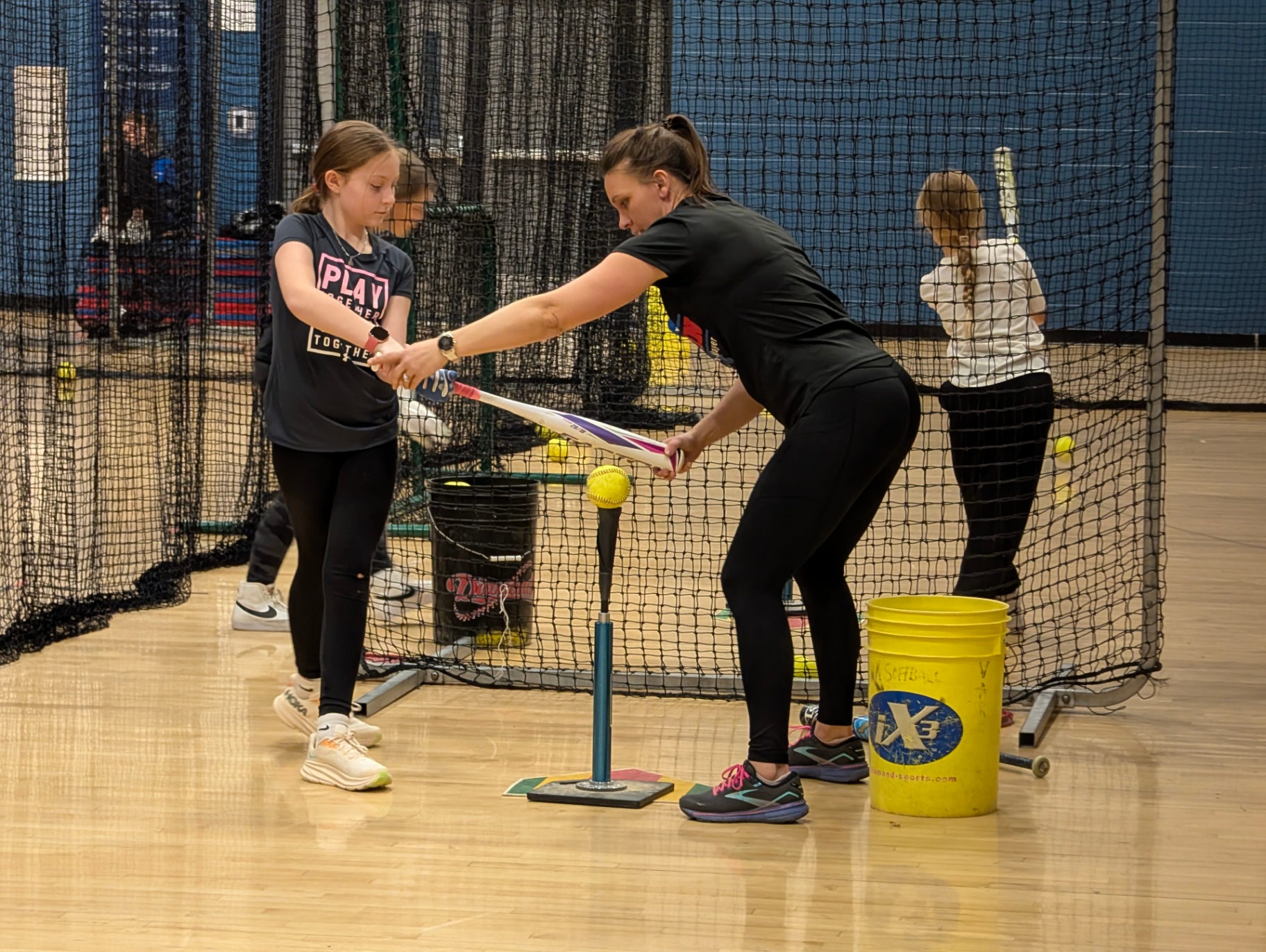 Bethany working hands-on with a player on hitting form at The Lab