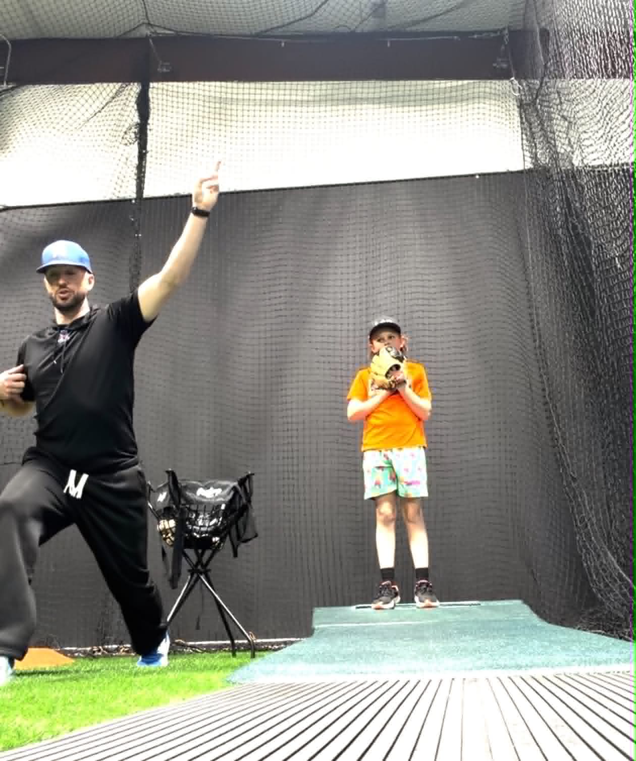 Pat Tschida coaching a young player during a pitching lesson at The Lab