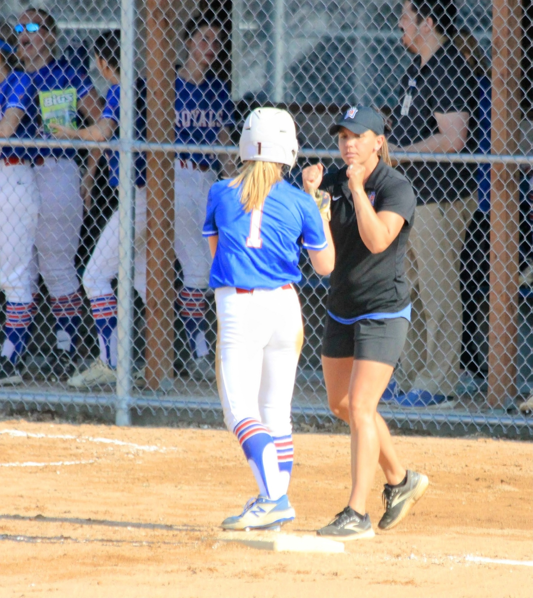 Bethany congratulating a Royals player at first base