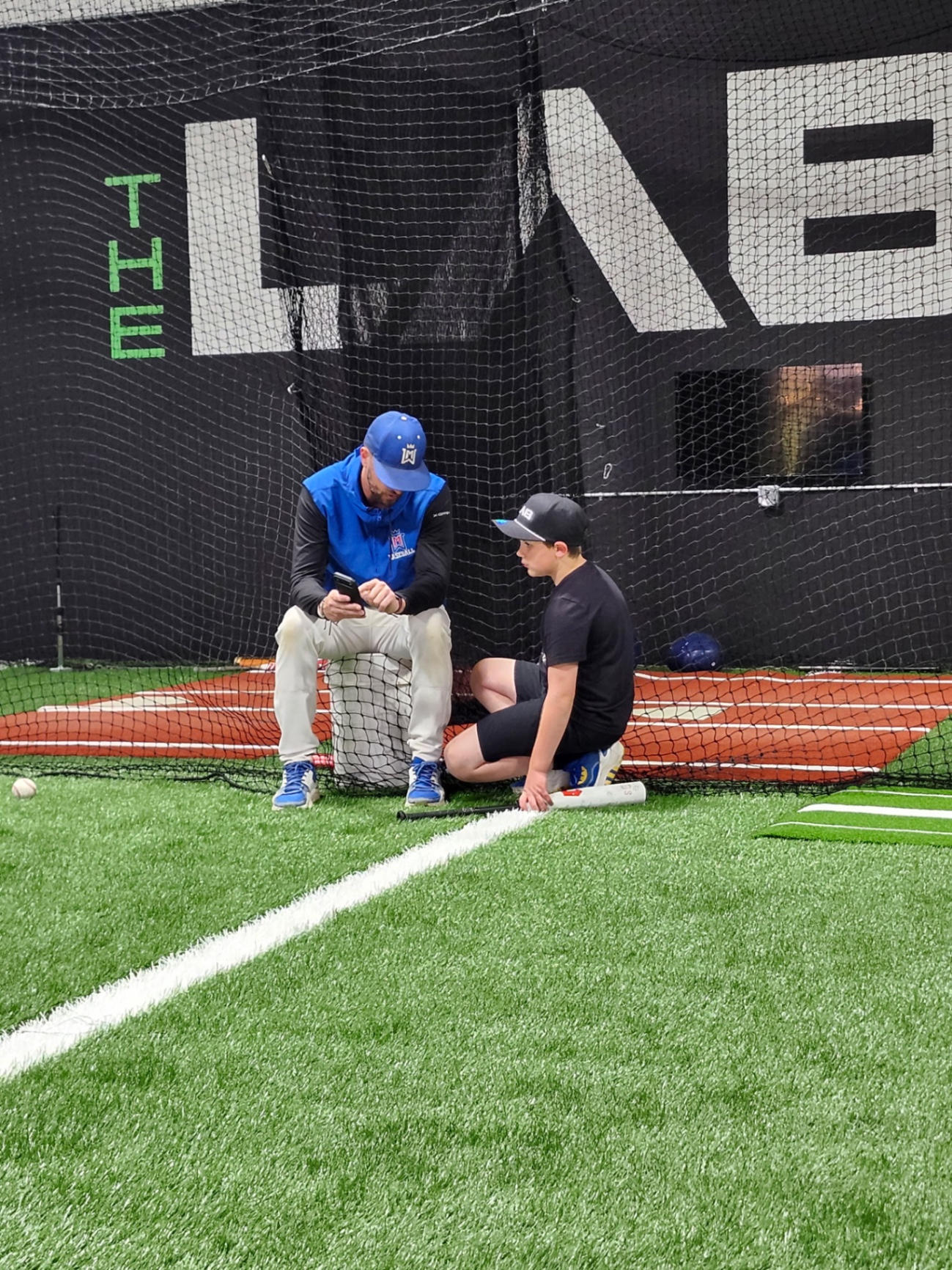 Coach working with player on swing